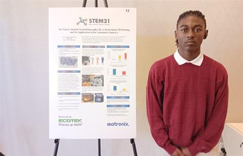 Dylan W. posing with project